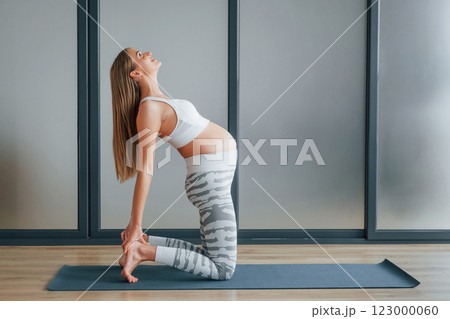 Pregnant woman in sportive clothes is in the studio Pregnant woman in sportive clothes is in the studio 123000060