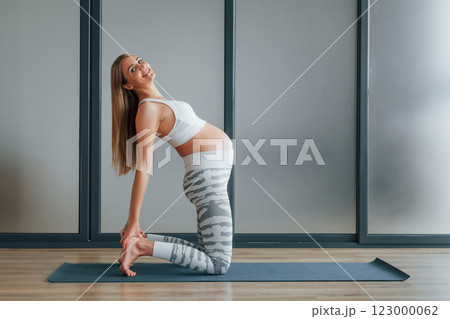 Pregnant woman in sportive clothes is in the studio Pregnant woman in sportive clothes is in the studio 123000062