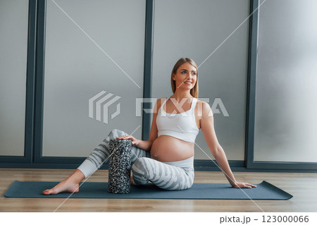 Yoga for pregnant. Woman in sportive clothes is in the studio 123000066