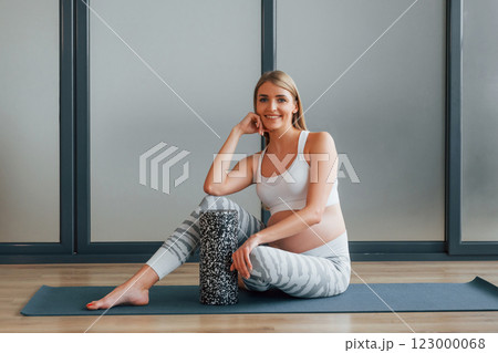 Yoga for pregnant. Woman in sportive clothes is in the studio 123000068