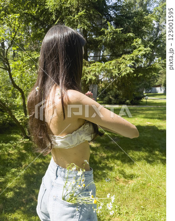 Side view of young woman doing yoga in the park Side view of young woman doing yoga in the park 123001595