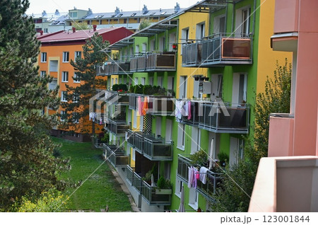 Original prefabricated houses on a housing estate from the communist era in Eastern and Central Europe after reconstruction.. Facade of a modern apartment building with windows and balconies. Czech Original prefabricated houses on a housing estate from the communist era in Eastern and Central Europe after reconstruction.. Facade of a modern apartment building with windows and balconies. Czech 123001844