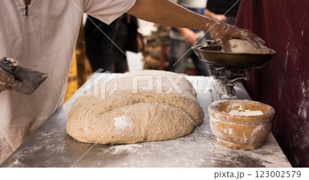 Male hands knead yeast dough for baking bread 123002579