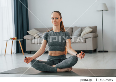 Domestic room. Young woman with slim body type and in yoga clothes is at home 123002965