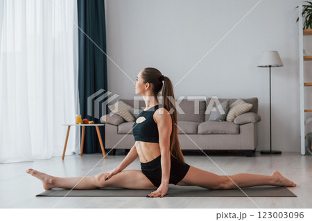 Slim body type. Young woman in yoga clothes is at home Slim body type. Young woman in yoga clothes is at home 123003096