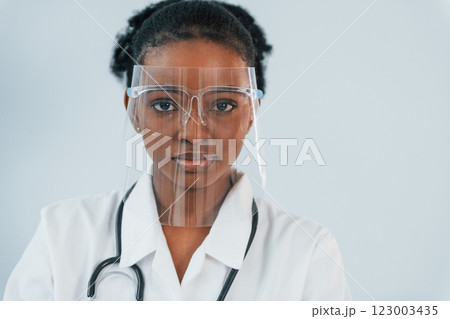 In protective equipment. Young african american woman is against white background 123003435