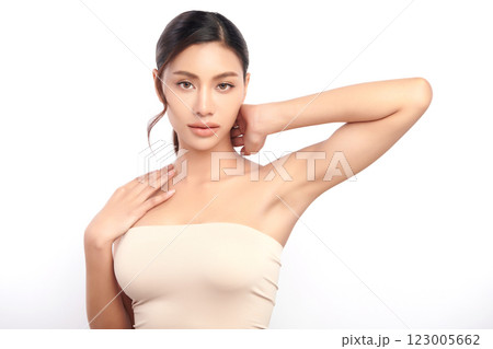 Beautiful Young Asian woman lifting hands up to show off clean and hygienic armpits or underarms on white background, Smooth armpit cleanliness and protection concept 123005662