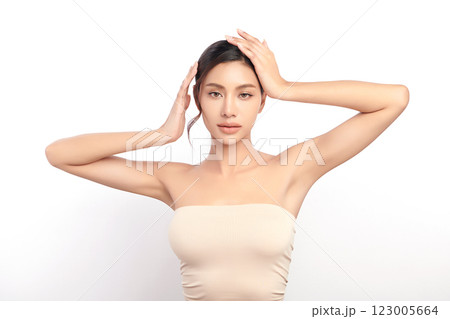 Beautiful Young Asian woman lifting hands up to show off clean and hygienic armpits or underarms on white background, Smooth armpit cleanliness and protection concept 123005664