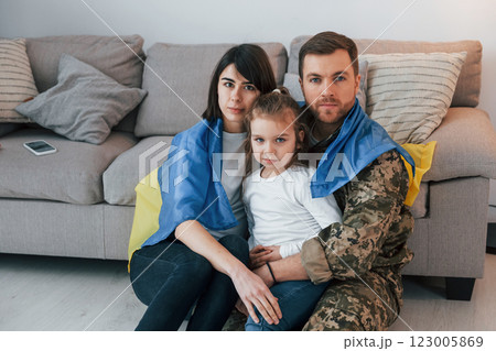 Supoort Ukraine conception. Soldier in uniform is at home with his wife and daughter Supoort Ukraine conception. Soldier in uniform is at home with his wife and daughter 123005869
