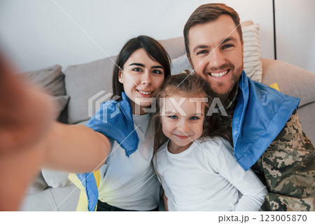 Supoort Ukraine conception. Soldier in uniform is at home with his wife and daughter Supoort Ukraine conception. Soldier in uniform is at home with his wife and daughter 123005870