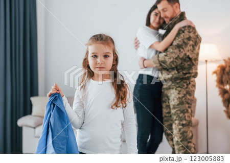 Ukrainian's hard times. Soldier in uniform is at home with his wife and daughter Ukrainian's hard times. Soldier in uniform is at home with his wife and daughter 123005883