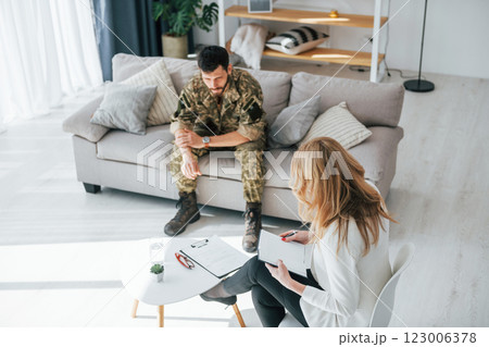 Having conversation. Soldier have therapy session with psychologist indoors Having conversation. Soldier have therapy session with psychologist indoors 123006378