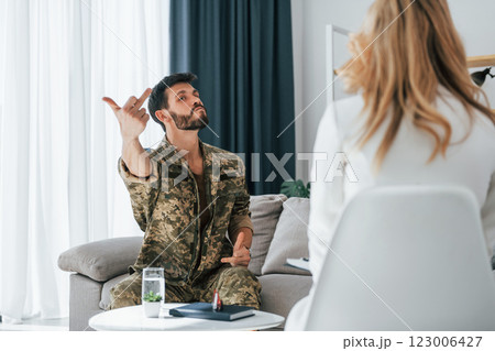 Horrible memories. Soldier have therapy session with psychologist indoors 123006427