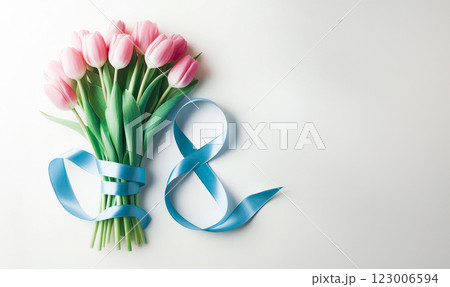 A bouquet of pink tulips lies next to the number eight of blue color from a satin ribbon on a pink background, A bouquet of pink tulips lies next to the number eight of blue color from a satin ribbon on a pink background, 123006594