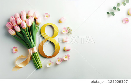 A bouquet of pink tulips lies next to the number eight of yellow color from a satin ribbon on a pink background, A bouquet of pink tulips lies next to the number eight of yellow color from a satin ribbon on a pink background, 123006597