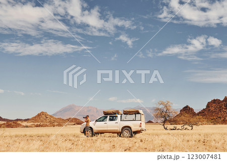 Photographer near car that is in the deserts of Africa, Namibia 123007481
