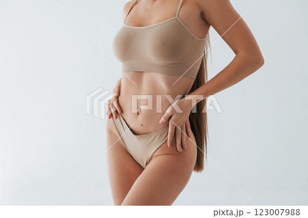 Particle view. Woman in underwear with slim body type is posing in the studio Particle view. Woman in underwear with slim body type is posing in the studio 123007988