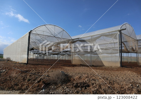 Greenhouses in agricultural landscape. Mediterranean agriculture, growing vegetables, fruits, flowers and other types of plants in greenhouses. 123008422