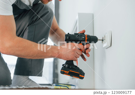 Close up view. Repairman is working indoors in the modern room 123009177