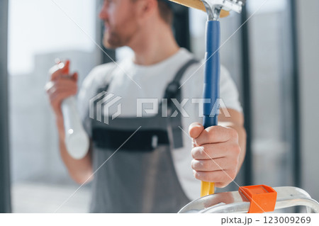 Repairman is working indoors in the modern room 123009269