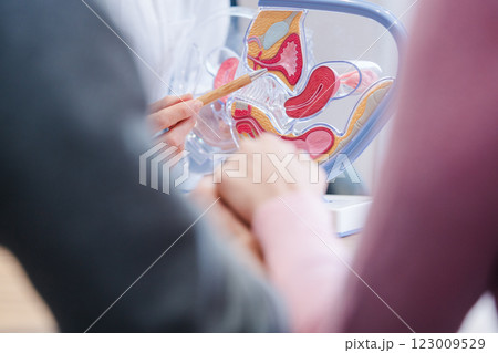 Couple wishing to have children in fertility clinic with doctor Couple wishing to have children in fertility clinic with doctor 123009529