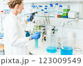 Female researcher testing chemicals in laboratory 123009549