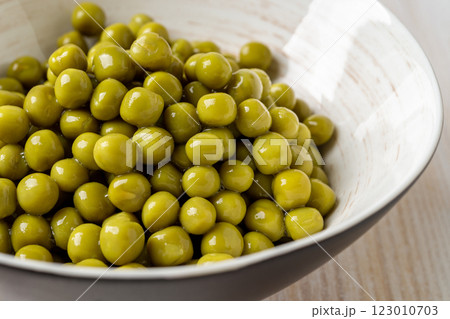 Canned organic green peas in a bowl close-up. Canned organic green peas in a bowl close-up. 123010703