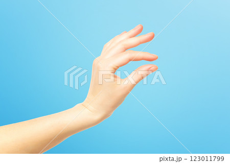 Female hand isolated at blue background making picking gesture. 123011799