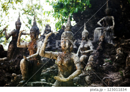 Row of old statues in secret buddhist garden. Concept of mysterious place for relaxation and meditation. 123011834