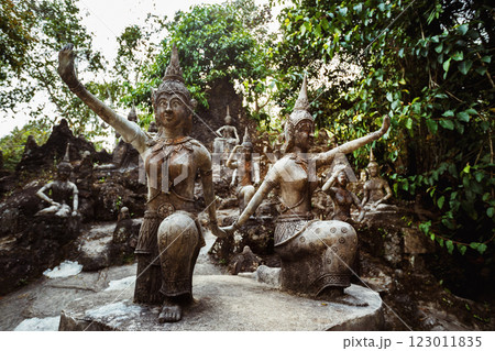 Row of old statues in secret buddhist garden. Concept of mysterious place for relaxation and meditation. 123011835