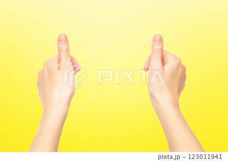 Closeup empty female hands making holding gesture isolated at yellow background. 123011941
