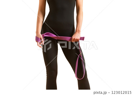 Slim athlete woman is holding trx straps for fitness training at isolated white background. 123012015