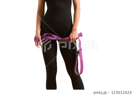 Slim athlete woman is holding trx straps for fitness training at isolated white background. Slim athlete woman is holding trx straps for fitness training at isolated white background. 123012028