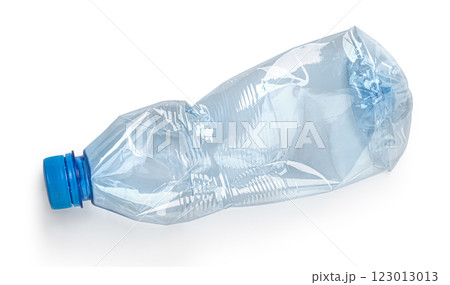 Crushed plastic bottle lying on white background representing recycling 123013013