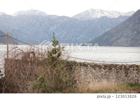 Serene view of a mountainous landscape with a tranquil waterfront in winter setting, showcasing natures beauty in a quiet location of Montenegro Serene view of a mountainous landscape with a tranquil waterfront in winter setting, showcasing natures beauty in a quiet location of Montenegro 123013826