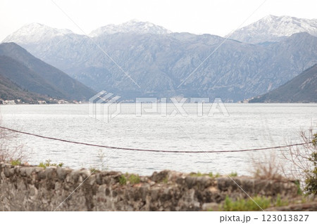 Stunning view of Montenegro mountains and calm waters along a serene bay landscape captured at dawn Stunning view of Montenegro mountains and calm waters along a serene bay landscape captured at dawn 123013827