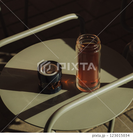 Cozy Afternoon Sipping a Warm Cup of Tea and Enjoying the Gentle Glow of a Candle on the Table 123015034