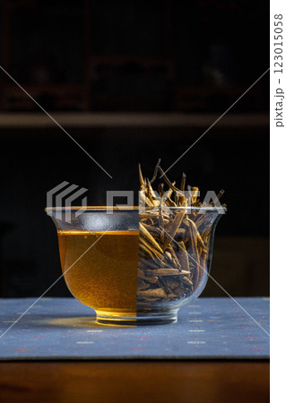A Delicate Herbal Tea is served in a Glass Bowl with Twigs, creating a serene ambiance A Delicate Herbal Tea is served in a Glass Bowl with Twigs, creating a serene ambiance 123015058