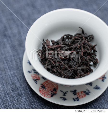 A beautifully crafted bowl holds dried black tea leaves, highlighting elegance and culture A beautifully crafted bowl holds dried black tea leaves, highlighting elegance and culture 123015087