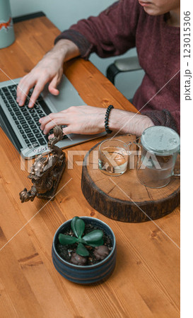 A Stylish and Inviting Workspace Featuring a Laptop, Refreshing Drink, and Beautiful Decor Elements 123015306