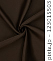 Close-up of twisted brown curtain fabric texture in smooth folds 123015503