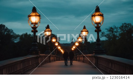 Evening stroll on a lit bridge. 123016414