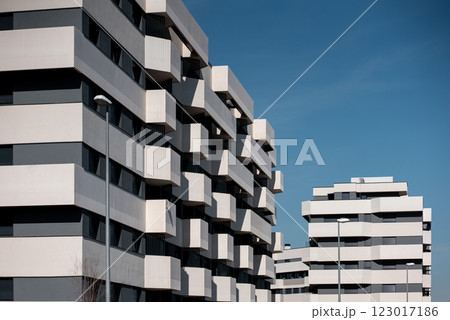 Modern suburb architectural buildings with unique design against clear blue sky in urban setting Modern suburb architectural buildings with unique design against clear blue sky in urban setting 123017186