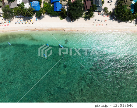 Colorful umbrellas line a sandy beach with turquoise water and small anchored boats. Koh Tao, Thailand. Colorful umbrellas line a sandy beach with turquoise water and small anchored boats. Koh Tao, Thailand. 123018646