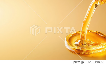Golden liquid pouring into smooth puddle, creating serene atmosphere Golden liquid pouring into smooth puddle, creating serene atmosphere 123019892