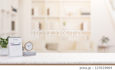 A desk with decorative items and empty space for display products, set in a minimalist living room. 123019964