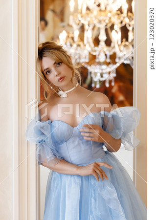 Elegant woman in a light blue ball gown in a luxurious classic interior Elegant woman in a light blue ball gown in a luxurious classic interior 123020370