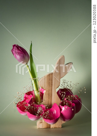 Creative vibrant handmade Easter table decoration with egg shells wooden bunny on pastel green background copy space. Greeting card idea Easter home tradition Seasonal sustainable 123020388