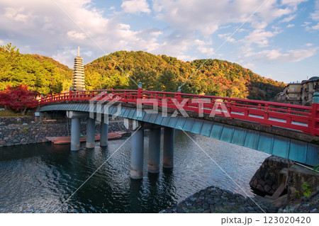 Bridge across Uji river to thirteen storied pagoda in autumn, Kyoto Bridge across Uji river to thirteen storied pagoda in autumn, Kyoto 123020420
