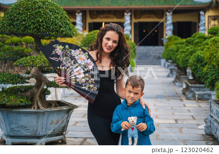 family of tourists mom and son at Buddhist temple at Linh Ung Pagoda in Da Nang in Vietnam. Travel and tourism in Asia 123020462